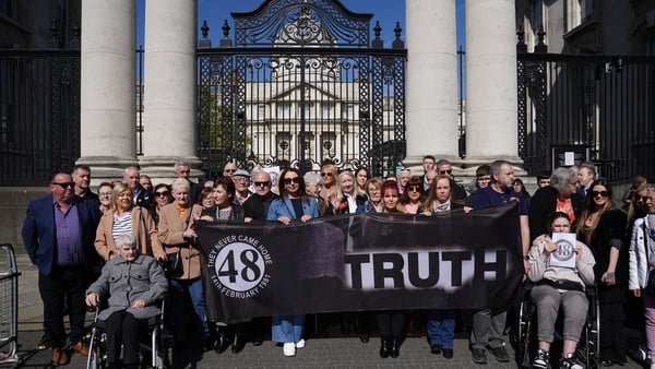Families of the survivors and victims of the Stardust fire gather outside Government buildings in Dublin