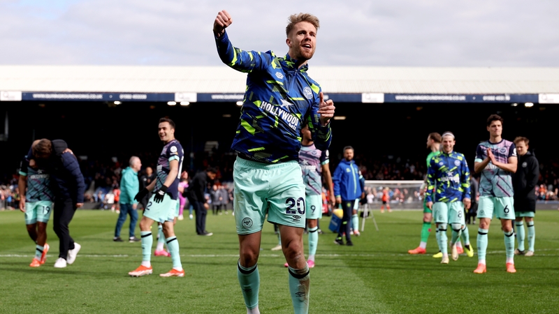 Kristoffer Ajer celebrates with the travelling Brentford fans