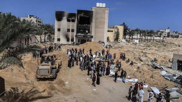 Civil Defence Authority teams remove bodies from under the rubble in Khan Yunis, Gaza