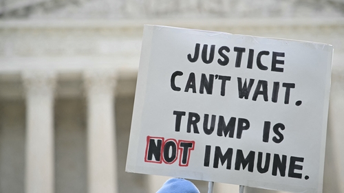 Anti-Trump protesters demonstrate outside the US Supreme Court before the hearing