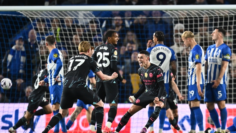 Phil Foden celebrates with Kevin De Bruyne after scoring a free-kick against Brighton