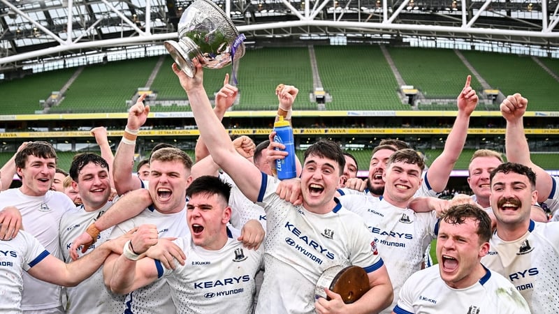 An elated Cork Constitution captain David Hyland lifts the trophy at the Aviva
