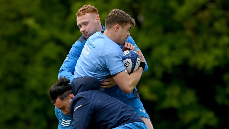 Garry Ringrose is tackled by Ciarán Frawley (top) and James Lowe during Leinster training on Monday