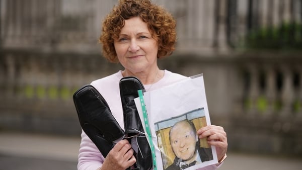Marjorie Roddy holds the shoes of her uncle William McGreanery
