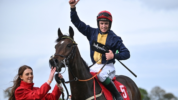 JJ Slevin celebrates on Fastorslow with groom Therese Sweeney after winning the Ladbrokes Punchestown Gold Cup