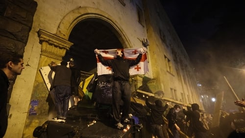 Protesters set up a barricade to block the side entrance of the Georgian parliament during a rally against the 'foreign agents' bill