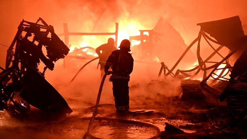 Ukrainian firefighters work to extinguish a fire at the site of a drone attack on industrial facilities in Kharkiv