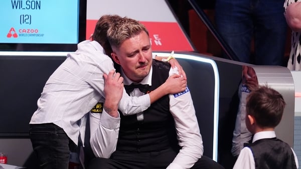 Kyren Wilson reacts with his children Finley (L) and Bailey after winning the World Snooker Championship final