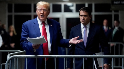 Donald Trump, pictured with his defence lawyer Todd Blanche, outside court today