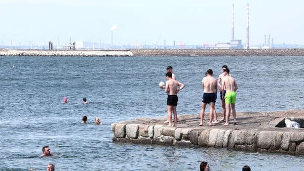 Members of the public enjoying the sunshine in Sandycove, Dublin