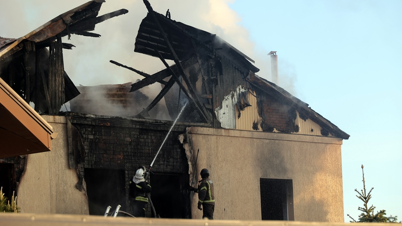 Smoke rises over a house after a Russian missile attack at night on Kharkiv with an S-300 missile