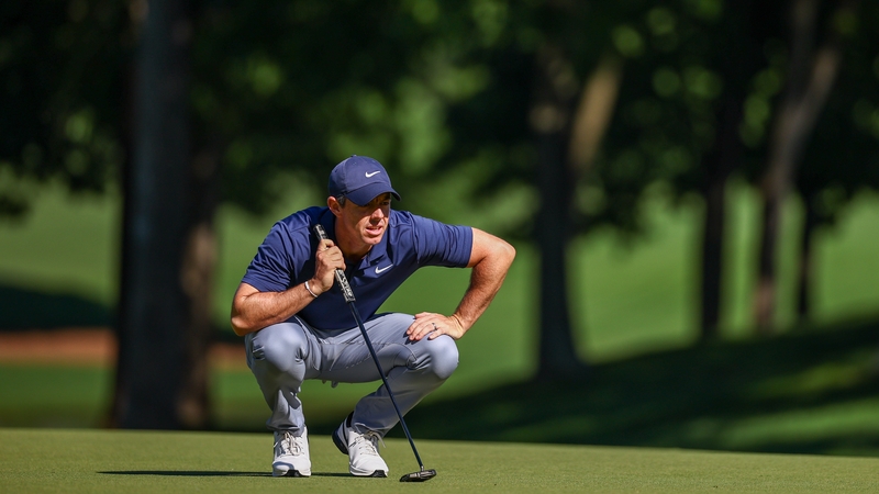 Rory McIlroy looks over a putt on the 15th