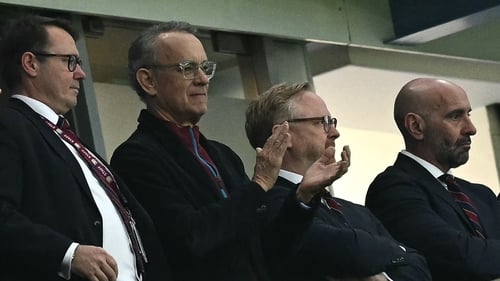 Tom Hanks (second from left), applauds ahead of the English Premier League football match between Aston Villa and Liverpool at Villa Park in Birmingham, central England on Monday. (Photo by Ben Stansall / AFP)