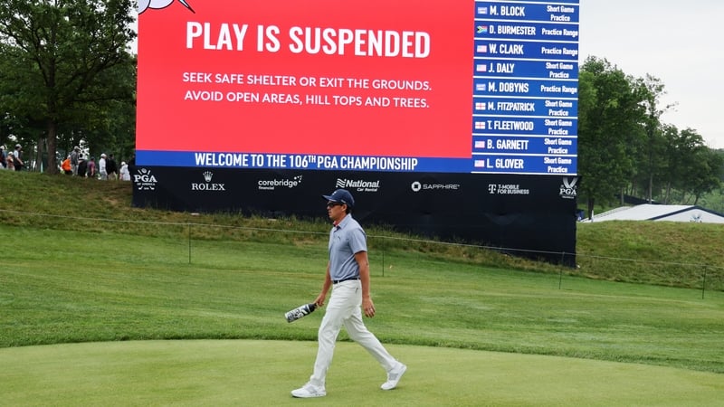 Rickie Fowler leaving the course as a result of the weather warning