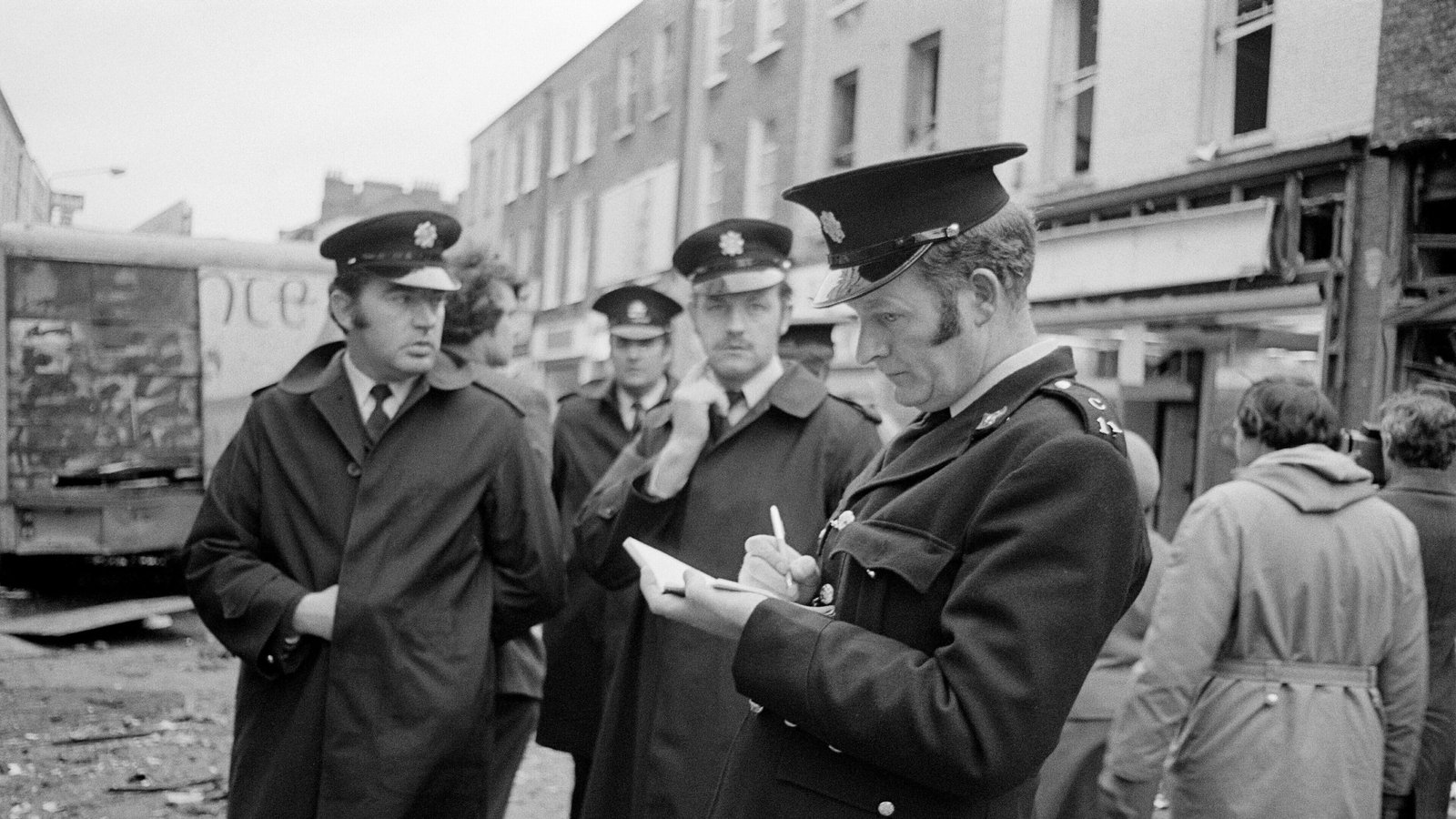 A guard takes notes in front of his colleagues on Talbot Street in Dublin city centre (RTÉ Stills Department)