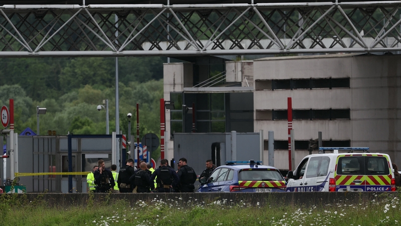 Police officers examine the scene at the tollbooth in Incarville in France