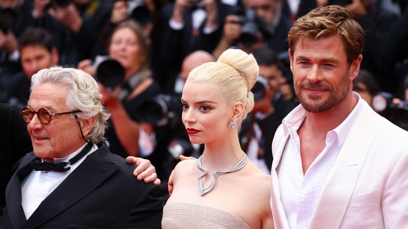 (L-R) George Miller, Anya Taylor-Joy, and Chris Hemsworth on the red carpet at Cannes