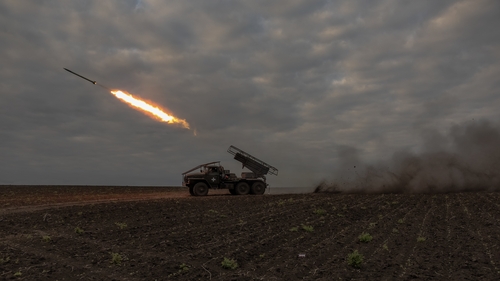 Ukrainian soldiers fire a multiple rocket launcher toward Russian positions in the Kharkiv region