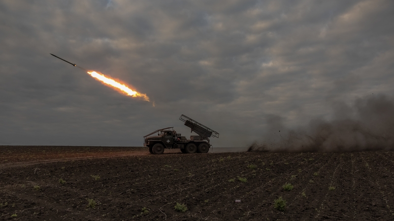 Ukrainian soldiers fire a multiple rocket launcher toward Russian positions in the Kharkiv region