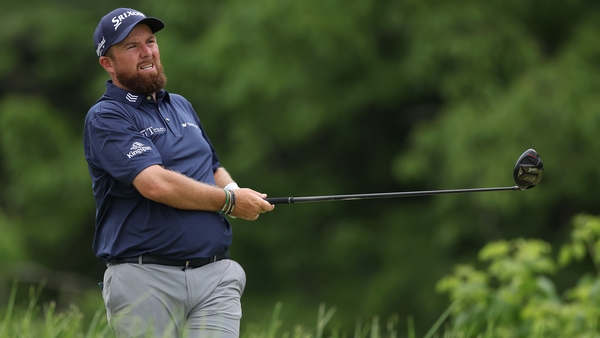 Lowry watches his tee shot on the fourth