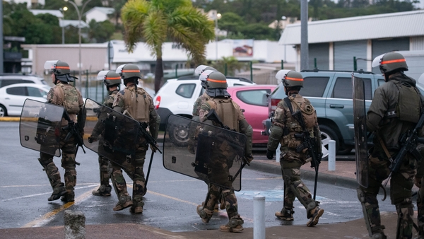 Reinforcements began landing yesterday at La Tontouta International Airport and could be seen moving through the capital Noumea in red berets, toting rifles, gas masks and riot shields