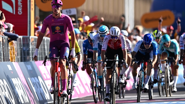 Jonathan Milan celebrates at the finish line as stage winner