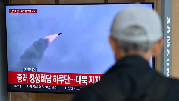 A man watches a television showing a news broadcast with file footage of a North Korean missile test, at a railway station in Seoul on 17 May