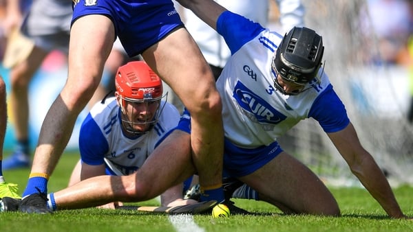 Waterford players, Tadhg de Burca, centre, and Mark Fitzgerald watch the ball go out which ends up being a late '65 from which Clare scored the winning point