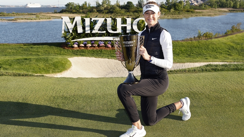 Nelly Korda poses with the winner's trophy
