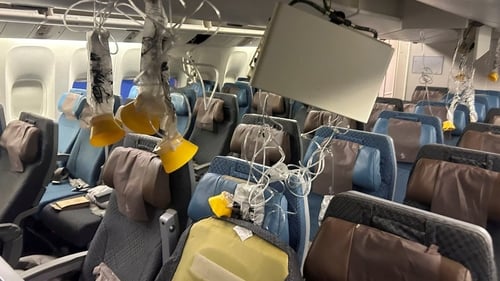 Photographs from inside the plane showed gashes in the overhead cabin panels, oxygen masks and panels hanging from the ceiling and luggage strewn around
