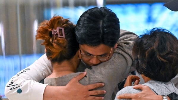 Passengers of Singapore Airlines flight SQ321 from London to Singapore greet family members upon arrival at Changi Airport in Singapore