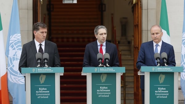 (L-R) Eamon Ryan, Simon Harris and Micheál Martin speaking to the media during a press conference outside Govt Buildings