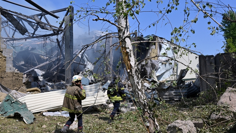 Ukrainian rescuers work at the site of a Russian missile attack in Kharkiv
