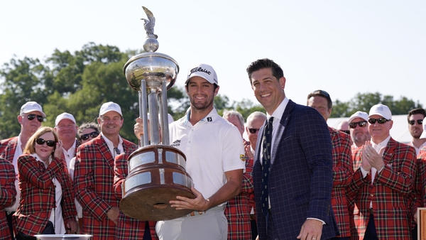 Davis Riley poses for a photo with the Leonard Trophy after winning the Charles Schwab Challenge