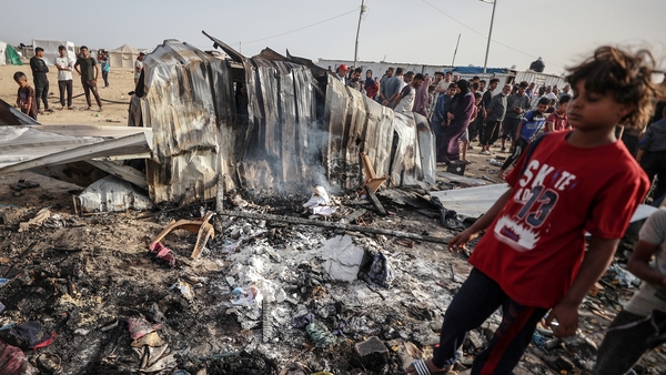 A young child is seen amid the destruction in Rafah