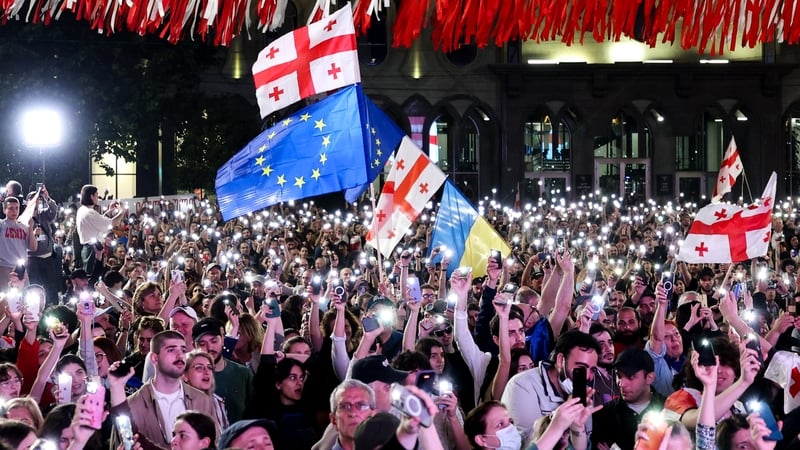 Georgians protest the adoption of a controversial 'foreign agent' law outside parliament