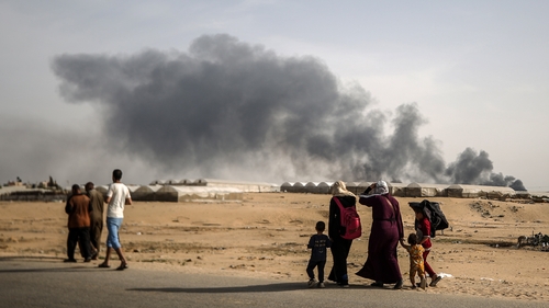 Palestinians, carrying their personal belongings with them, migrate to areas they consider safe after the Israeli army targeted tents in Al-Mawasi, previously declared as a 'safe zone' by Israel