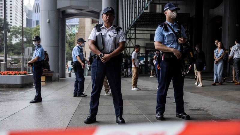 Scores of police officers and vehicles patrolled the High Court area as prison vehicles began bringing the 16 defendants to court