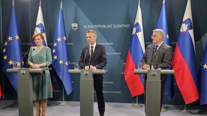 Slovenian Prime Minister Robert Golob (C) speaks during the press conference in Ljubljana