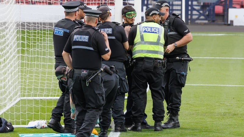 The goggled protestor is removed by police