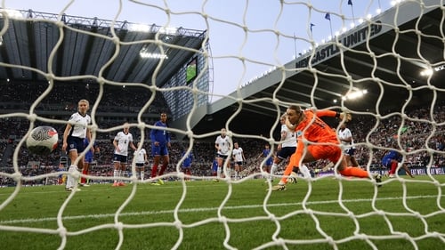 Marie-Antoinette Katoto shhoots past England goalkeeper Hannah Hampton at St James' Park