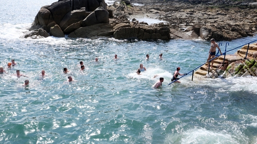 Swimmers jumping into the Forty Foot at Sandycove in Dublin as people enjoy the June bank holiday (Image: RollingNews.ie)