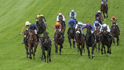 Ryan Moore riding City Of Troy (l, dark blue) to victory at the Epsom Derby