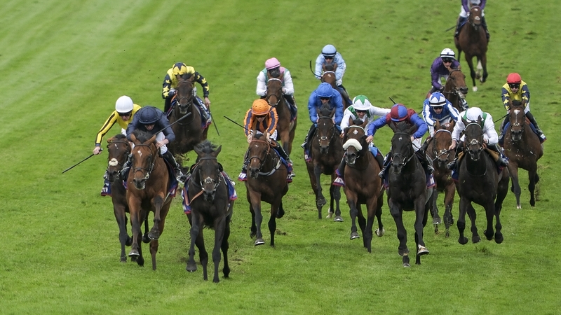 Ryan Moore riding City Of Troy (l, dark blue) to victory at the Epsom Derby