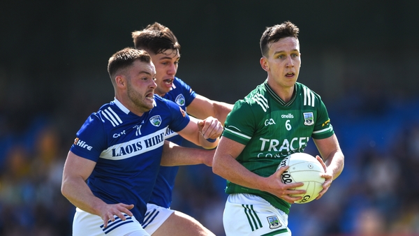 Fermanagh's Declan McCusker is tackled by Eoin Lowry of Laois