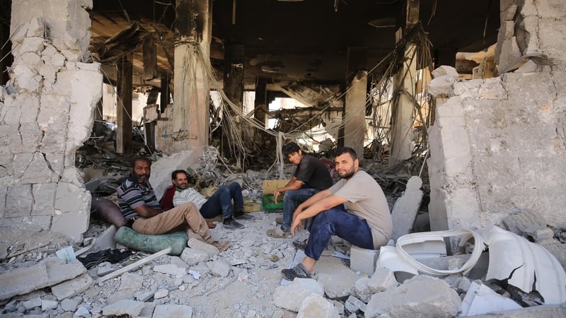 Palestinians are seen among the rubble of destroyed buildings as they return home after Israeli forces withdraw from Jabalia