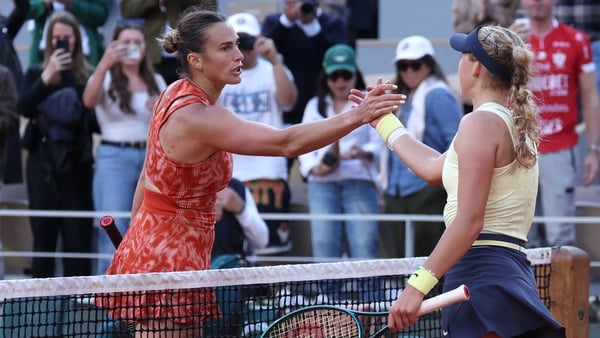 Mirra Andreeva shakes hands with Belarus' Aryna Sabalenka (L) after the match