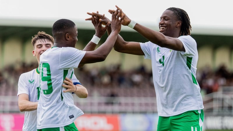 Bosun Lawal (R) celebrates with teammates Aidomo Emakhu and Andy Moran