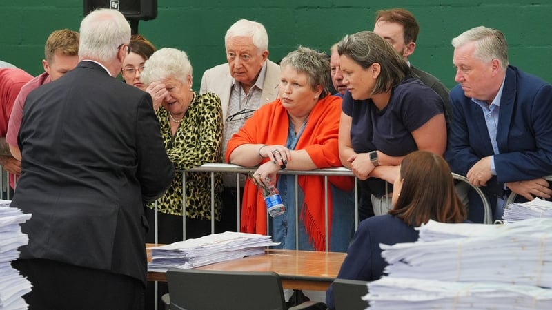 Candidates and agents observe as the returning officer presents them with doubtful ballots at Nemo Rangers GAA club in Cork