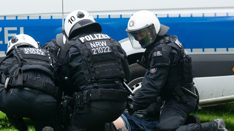 German police arrest a counter-protester at a rally of the far-right AFD party